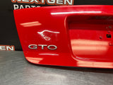 04-06 PONTIAC GTO LICENSE PLATE TRUNK FILLER PANEL TORRID RED OEM #1027