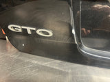04-06 PONTIAC GTO LICENSE PLATE TRUNK FILLER PANEL BLCK OEM #1691