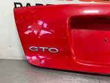 04-06 PONTIAC GTO LICENSE PLATE TRUNK FILLER PANEL RED #3801